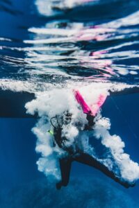 A vibrant underwater capture of a scuba diver amidst bubbles and reflections.